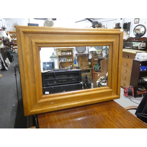 1058 - A large heavy pine framed mirror, measuring 120cm x 90cm in size.