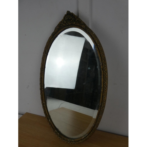 1062 - An oval wall mirror.