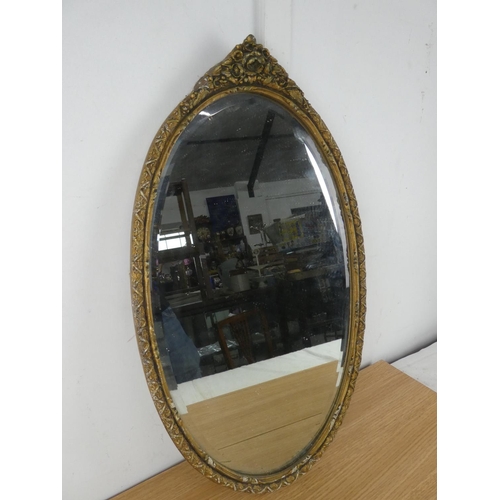 1062 - An oval wall mirror.