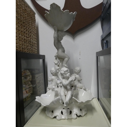 1092 - A large ceramic white cherub centrepiece with repairs, measuring 60cm in height.