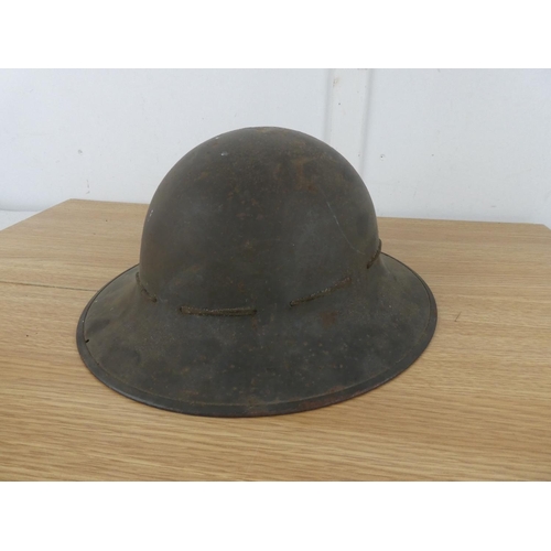 1118 - A vintage Military helmet with liner.