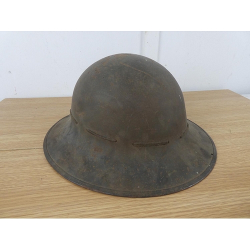 1118 - A vintage Military helmet with liner.