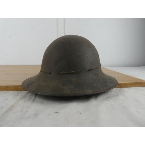 1118 - A vintage Military helmet with liner.