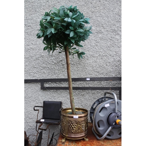 1128 - A brass effect plant pot with an artificial tree.