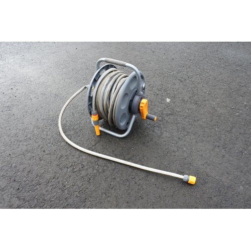 1130 - A garden hose and reel.