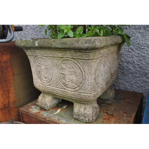 1132 - A concrete garden planter with a potted tree,