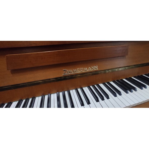 879 - An upright Zimmerman piano.