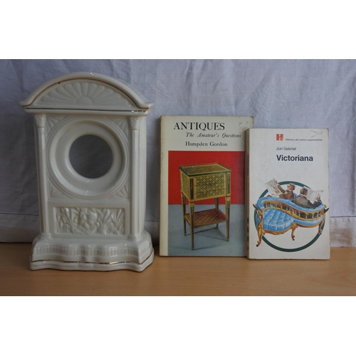 172 - A Belleek mantle clock case and two books.