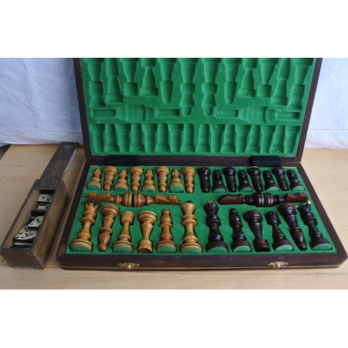 182 - A cased chess set and a vintage box of Dominos.