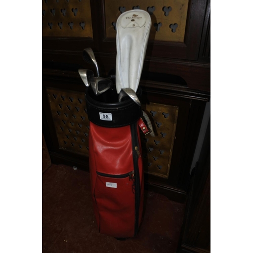 95 - A golf bag and clubs.