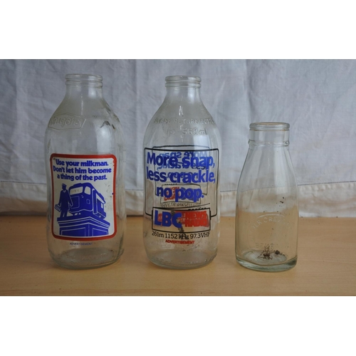 101 - Two vintage Unigate milk bottles and an Ulster Ceramics small milk bottle.