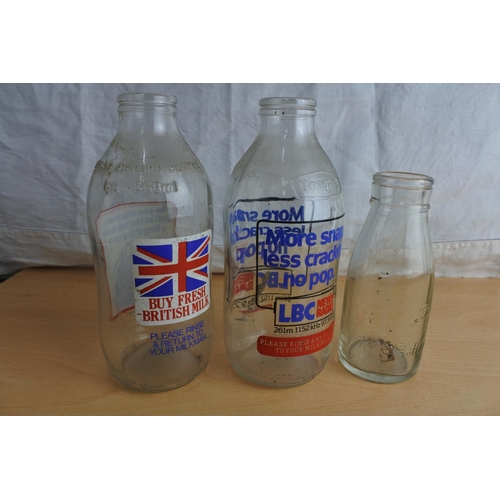 101 - Two vintage Unigate milk bottles and an Ulster Ceramics small milk bottle.