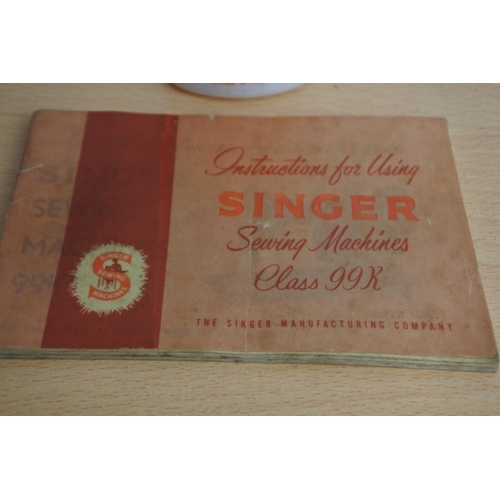 105 - A vintage Singer sewing machine manual and oil bottle.