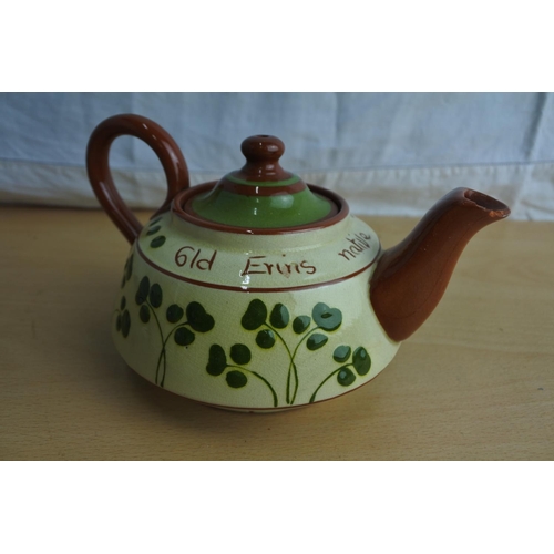 108 - A vintage terracotta shamrock patterned teapot (a/f).