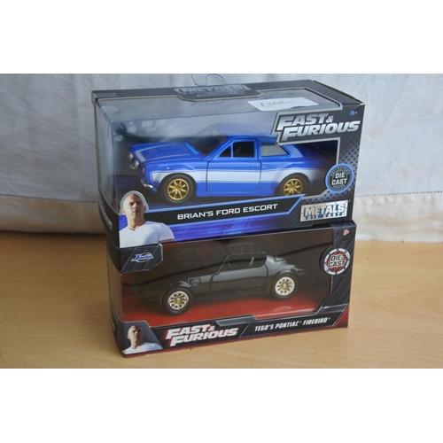 117 - Two boxed Jada 'Fast & Furious' die cast cars - Brian's Ford Escort and Tego's Pontial Firebird.