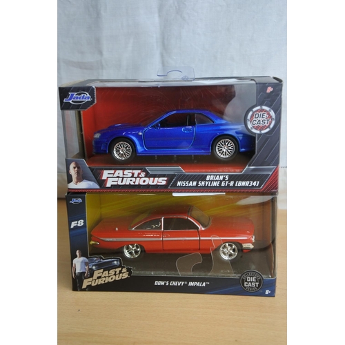 129 - Two boxed Jada 'Fast & Furious' die cast cars - Dom's Chevy Impala and Brian's Nissan Skyline GT-R (... 