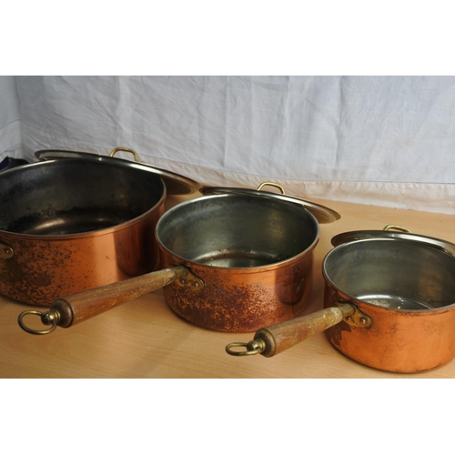 152 - A set of three copper lacquered lidded saucepans