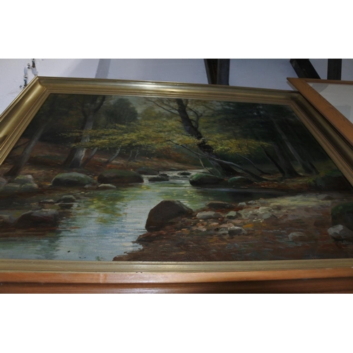 169 - A large framed oil painting of a forest scene signed by the artist. Measuring H-59cm W-78cm.