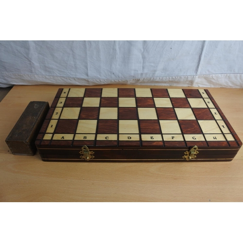 182 - A cased chess set and a vintage box of Dominos.