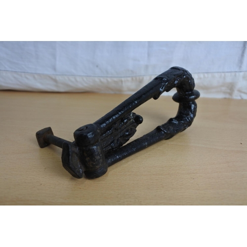 228 - An antique cast iron door knocker.