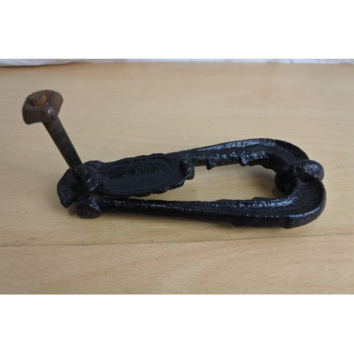 228 - An antique cast iron door knocker.