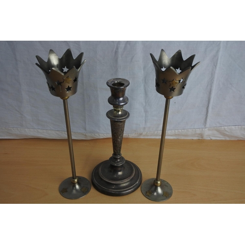 239 - A pair of decorative metal candlesticks and another.