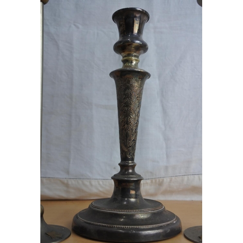 239 - A pair of decorative metal candlesticks and another.