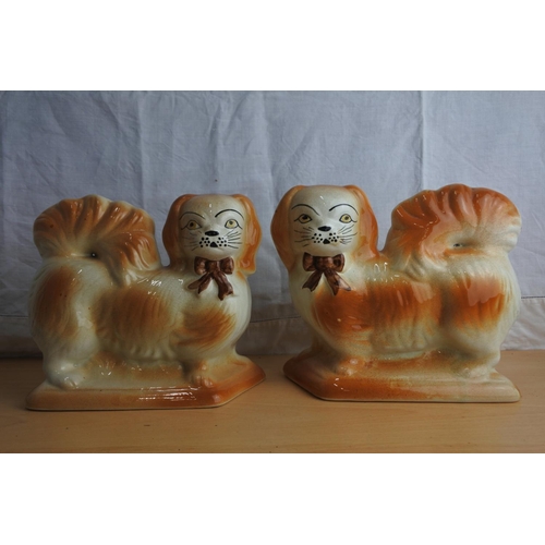 64 - An antique pair of mantle dogs.