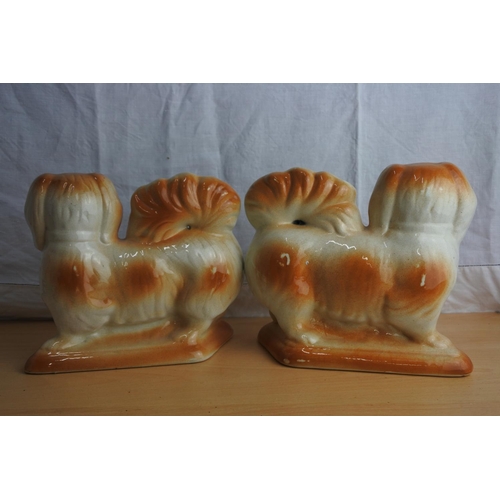 64 - An antique pair of mantle dogs.