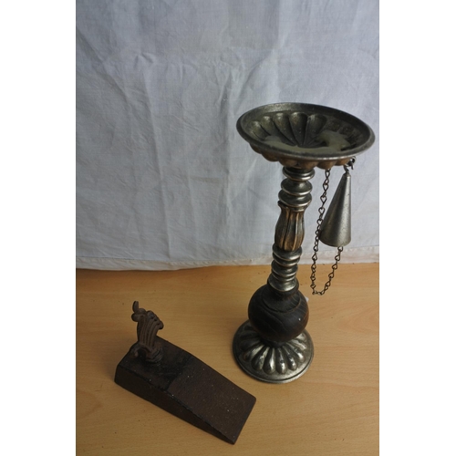 89 - A door stop and a wooden and metal candlestick and snuffer.