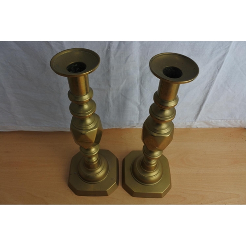 91 - A stunning pair of antique brass candlesticks stamped 'The King of Diamonds'.