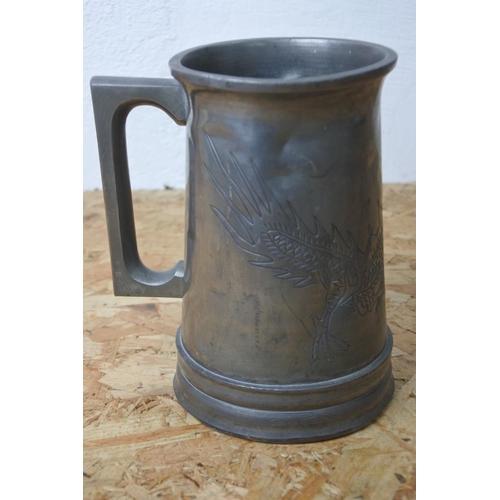 279 - A pewter tankard with dragon design.