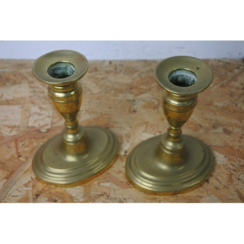 293 - A pair of brass candlesticks.