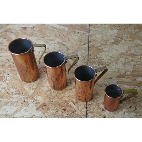 303 - A set of four copper measures.