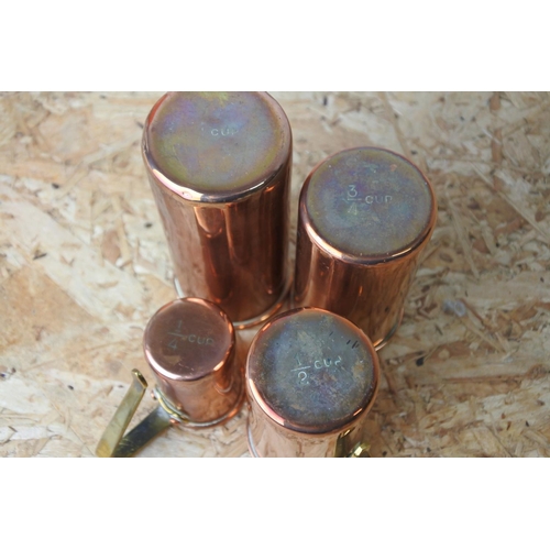 303 - A set of four copper measures.