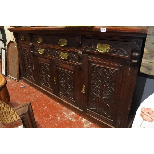 330 - A stunning antique ok four door sideboard with carved detail and original brass handles.