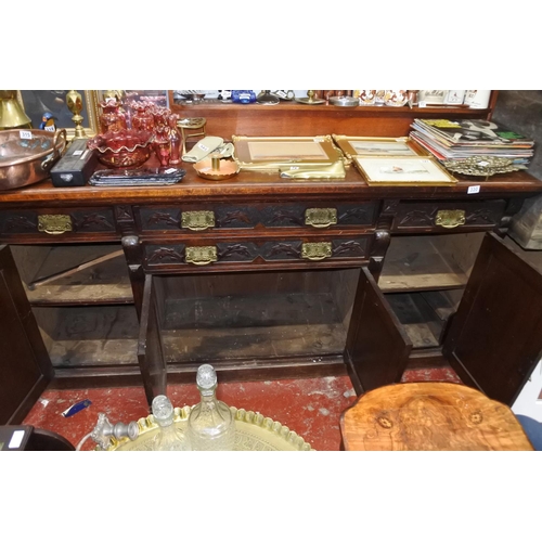 330 - A stunning antique ok four door sideboard with carved detail and original brass handles.