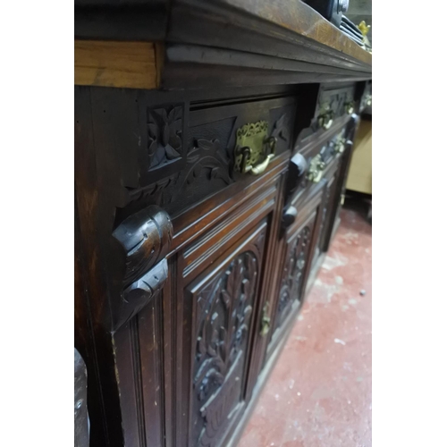 330 - A stunning antique ok four door sideboard with carved detail and original brass handles.