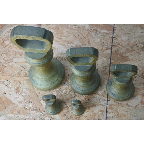 384 - A set of five brass shop weights