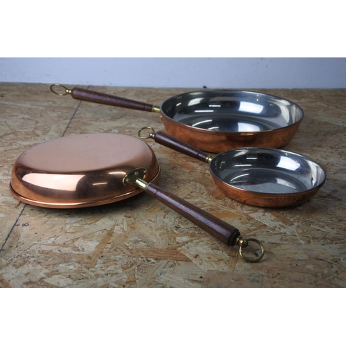 393 - A set of three copper pans.