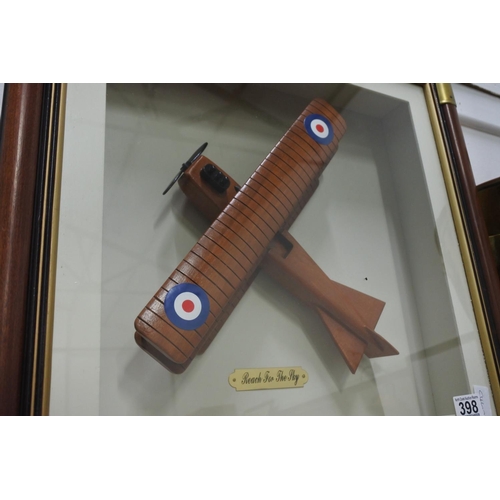 398 - A cased display of a wooden plane 'Reach for the Sky'.