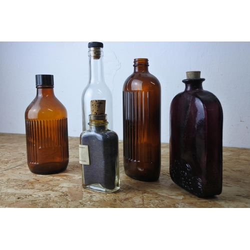 418 - A collection of various vintage glass bottles.