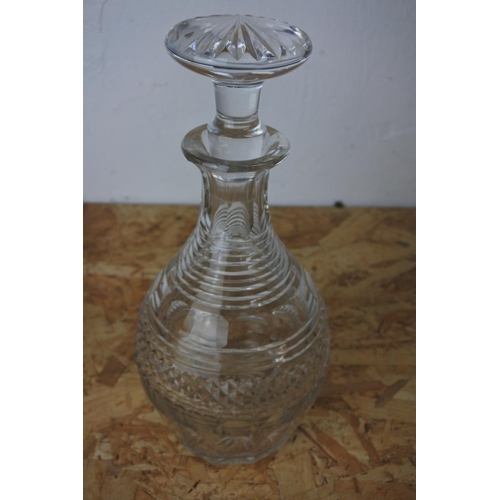 428 - A cut glass decanter and stopper.