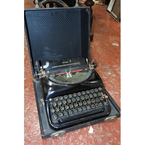 438 - A vintage cased Victor S typewriter.