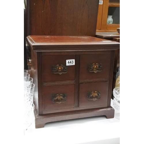 443 - A four drawer small mahogany chest.