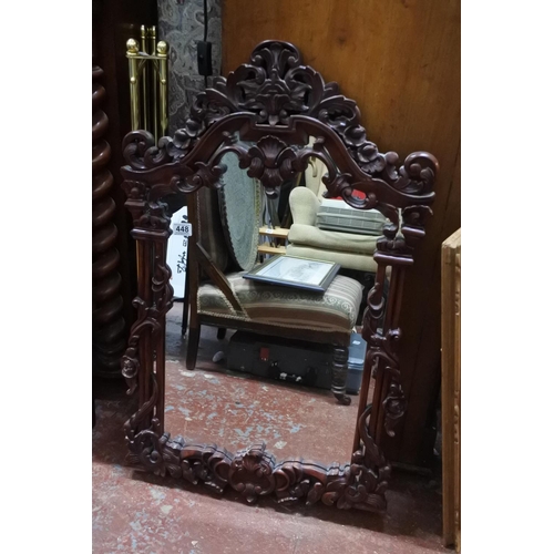 448 - A decorative wood framed wall mirror.