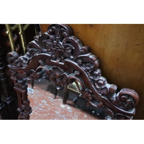 448 - A decorative wood framed wall mirror.