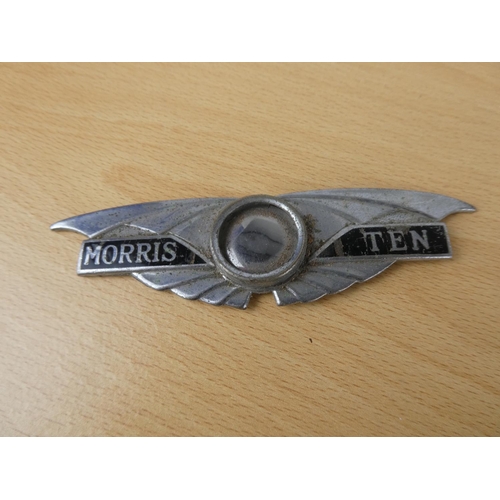 465 - An assorted lot of to include a Morris Ten car badge, candle snuffer and more.