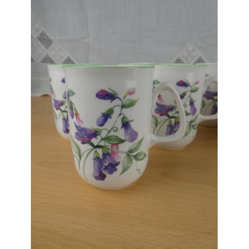 501 - A set of 11 Rose of England bone china mugs.