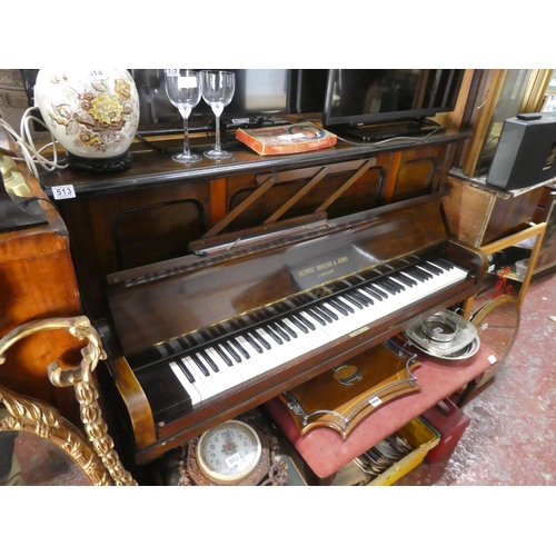 513 - A mahogany cased upright piano.